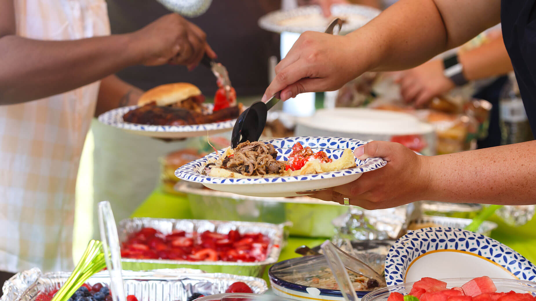 people taking food at a potluck