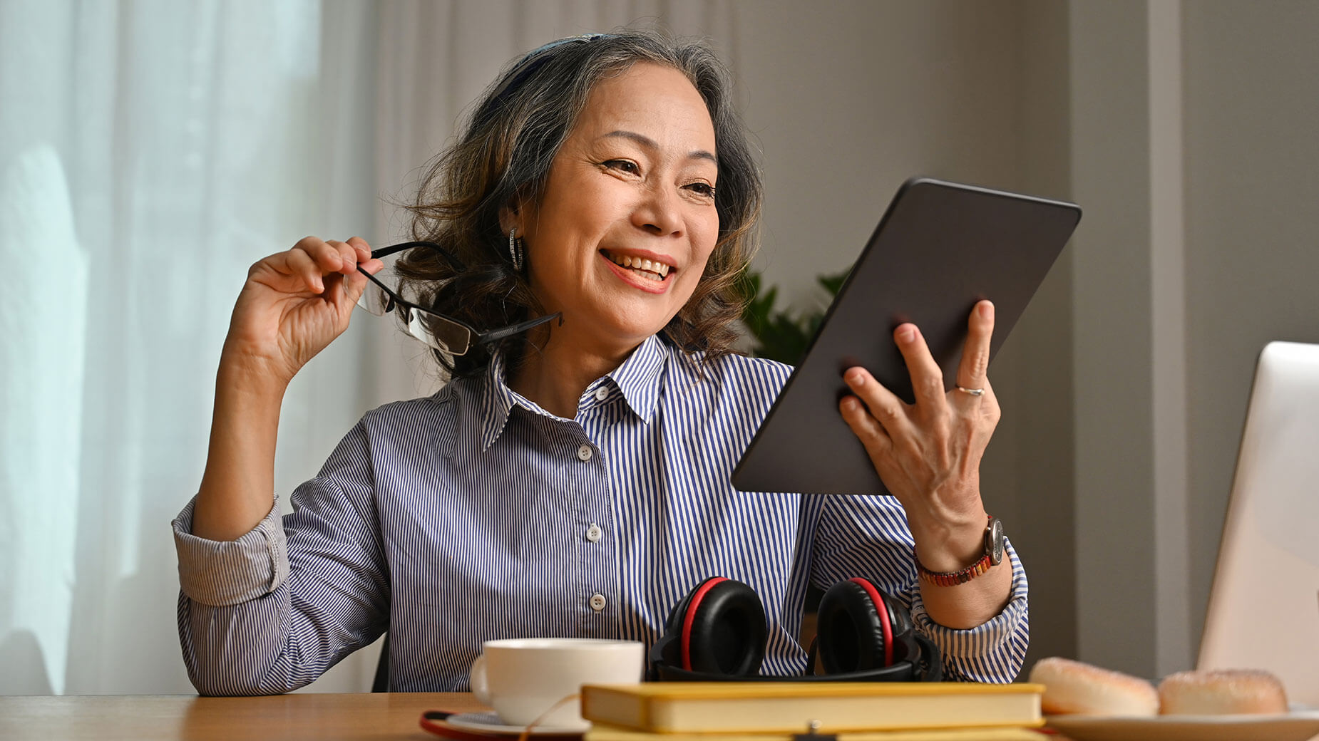 elderly woman holding a tablet